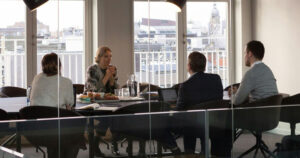 People having a meeting around a table in a board room